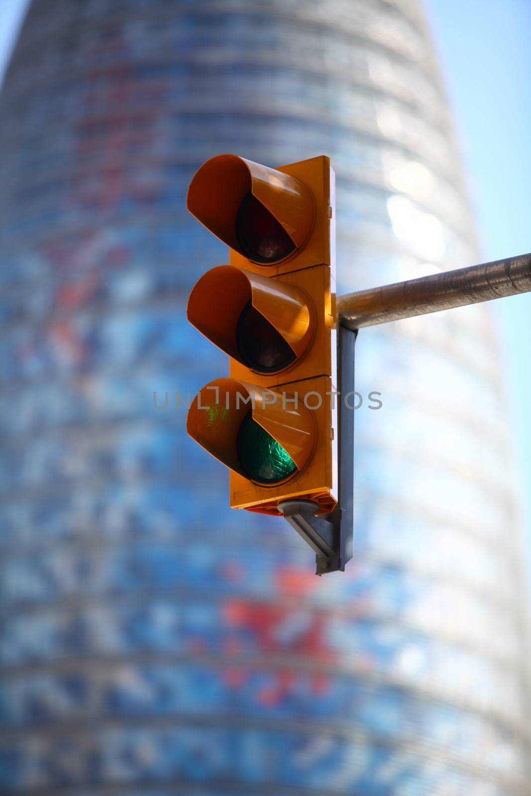 green  traffic light on the background of the cityscape