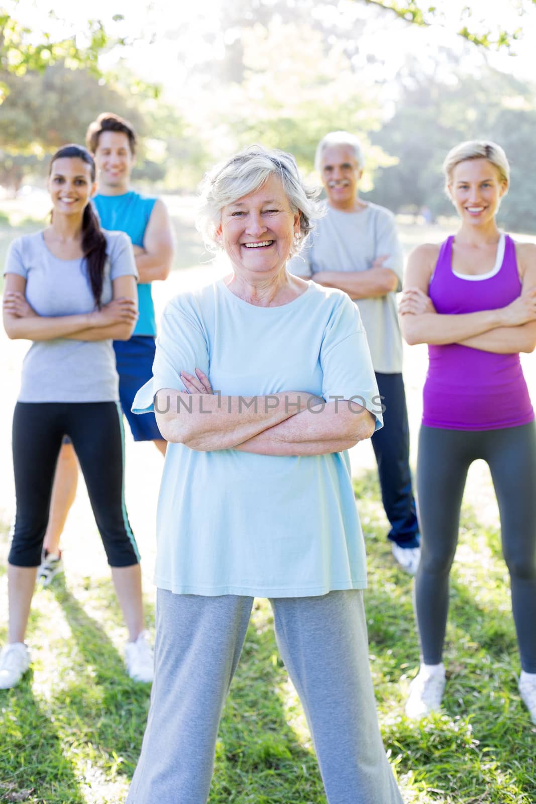 Happy athletic group with arms crossed  by Wavebreakmedia