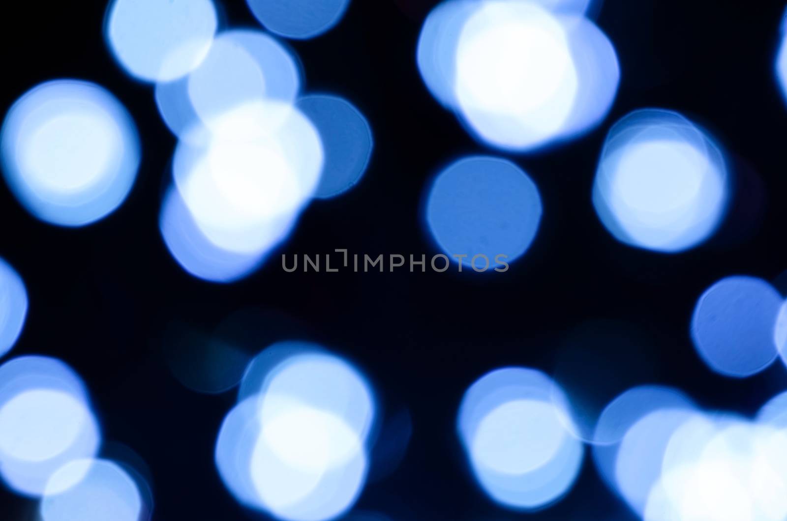 Black blue circle blur lights as christmas background.