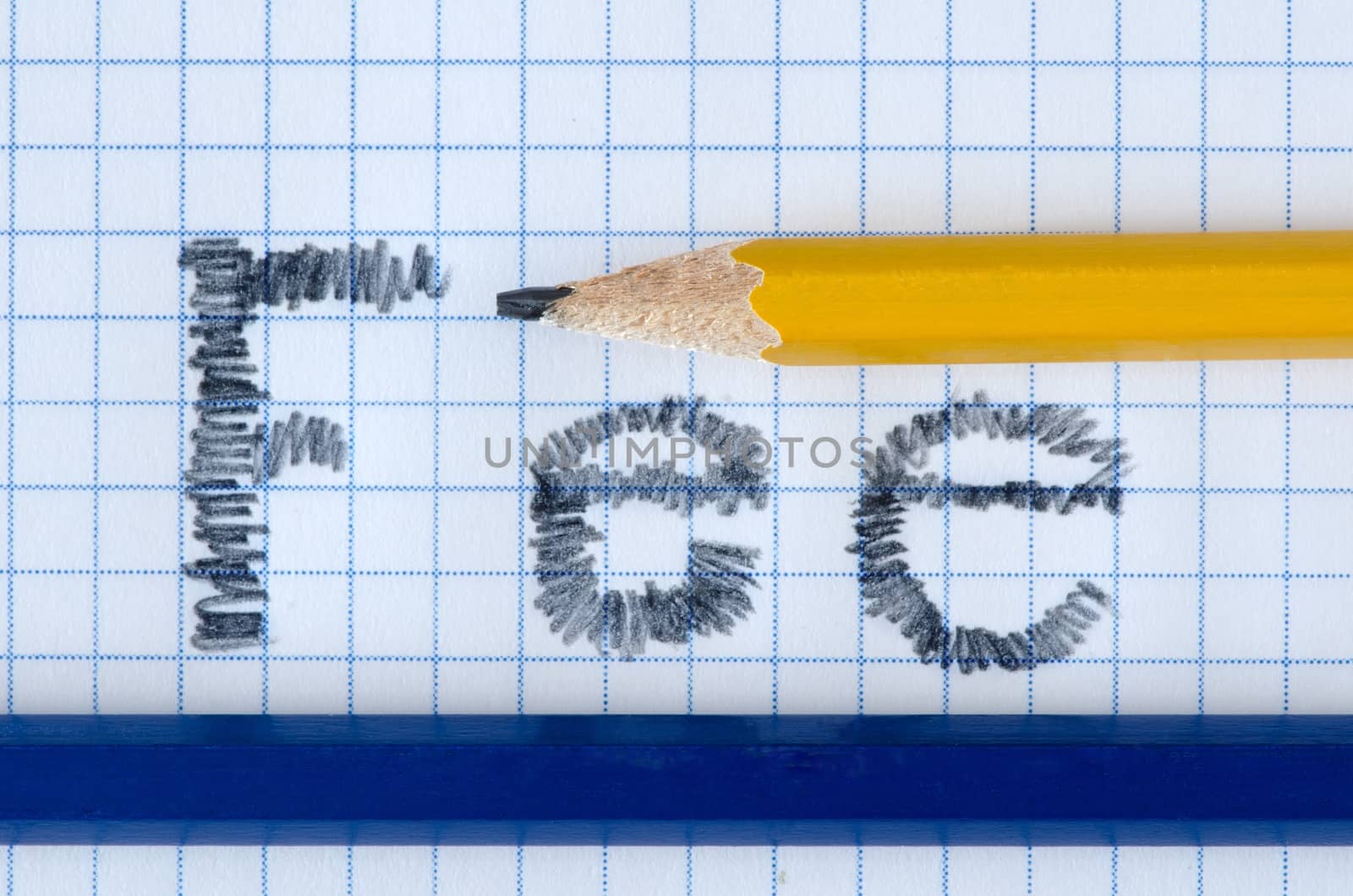 Fee word typed on white paper, yellow and blue pencil.