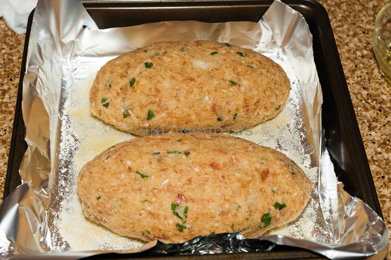 Two meatloaf lie on a baking sheet before they begin to oven-roasted