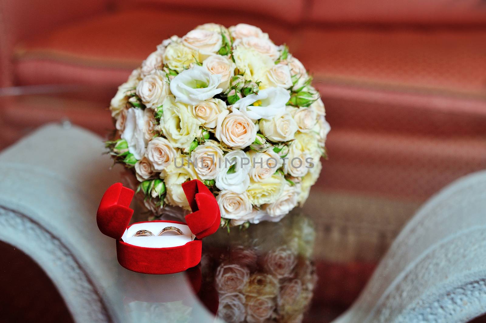 Pair of wedding rings and wedding bouquet.