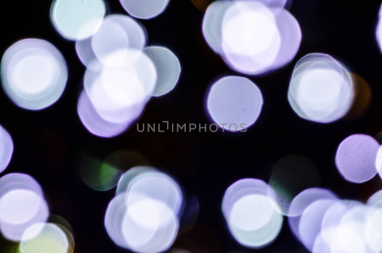 White violet purple circle lights isolated on black background.
