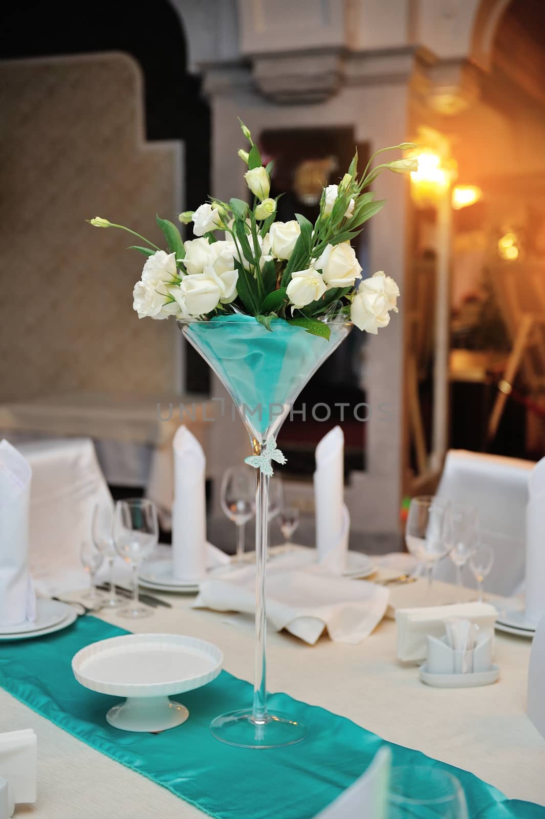 wedding decorations in the restaurant with flowers on table.