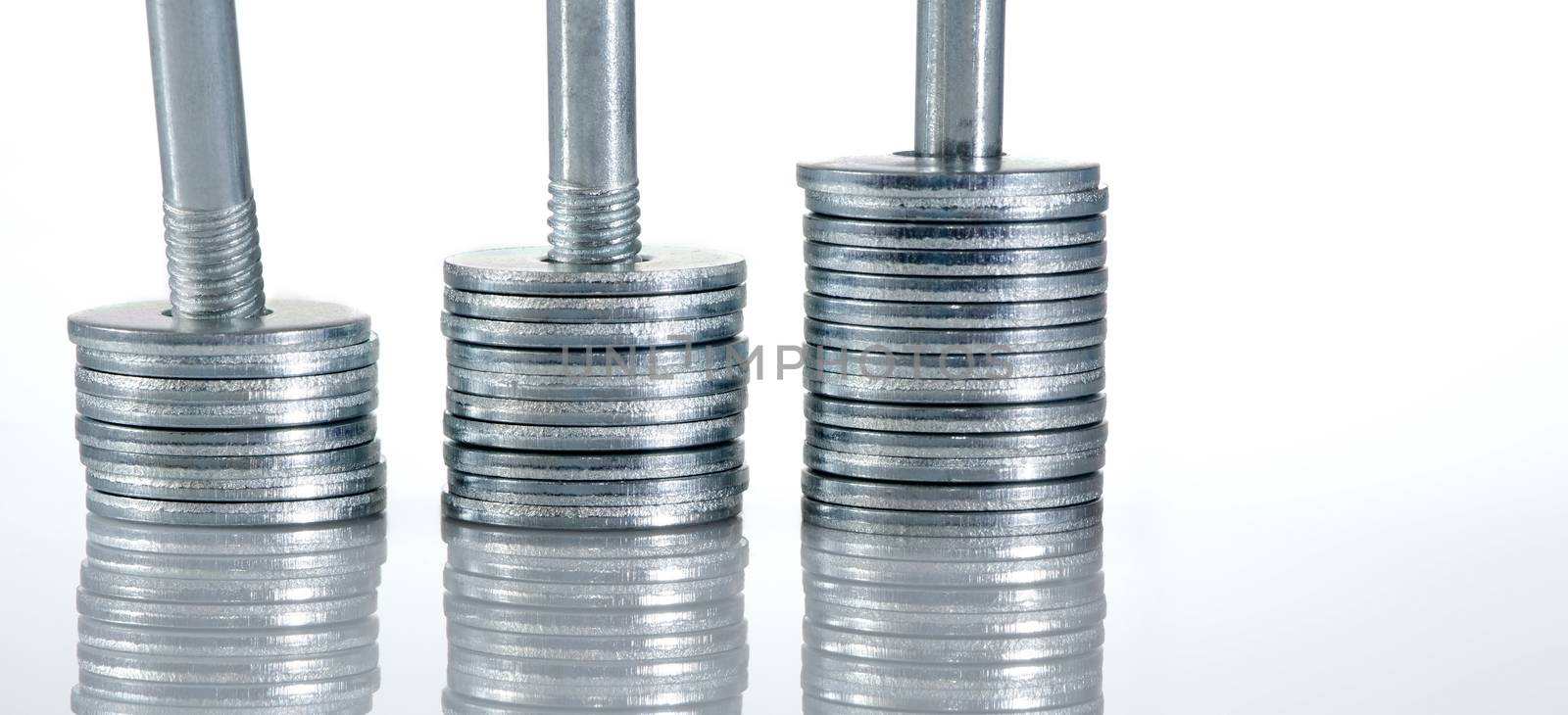 Three screw washer columns with reflection, white grey background.