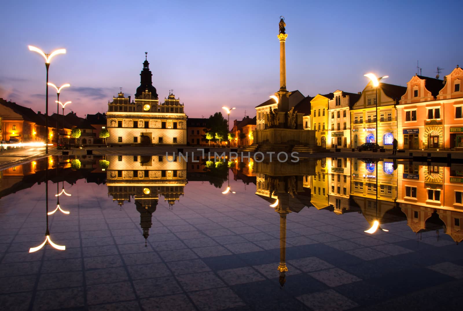 Town square at night and reflection in the water.