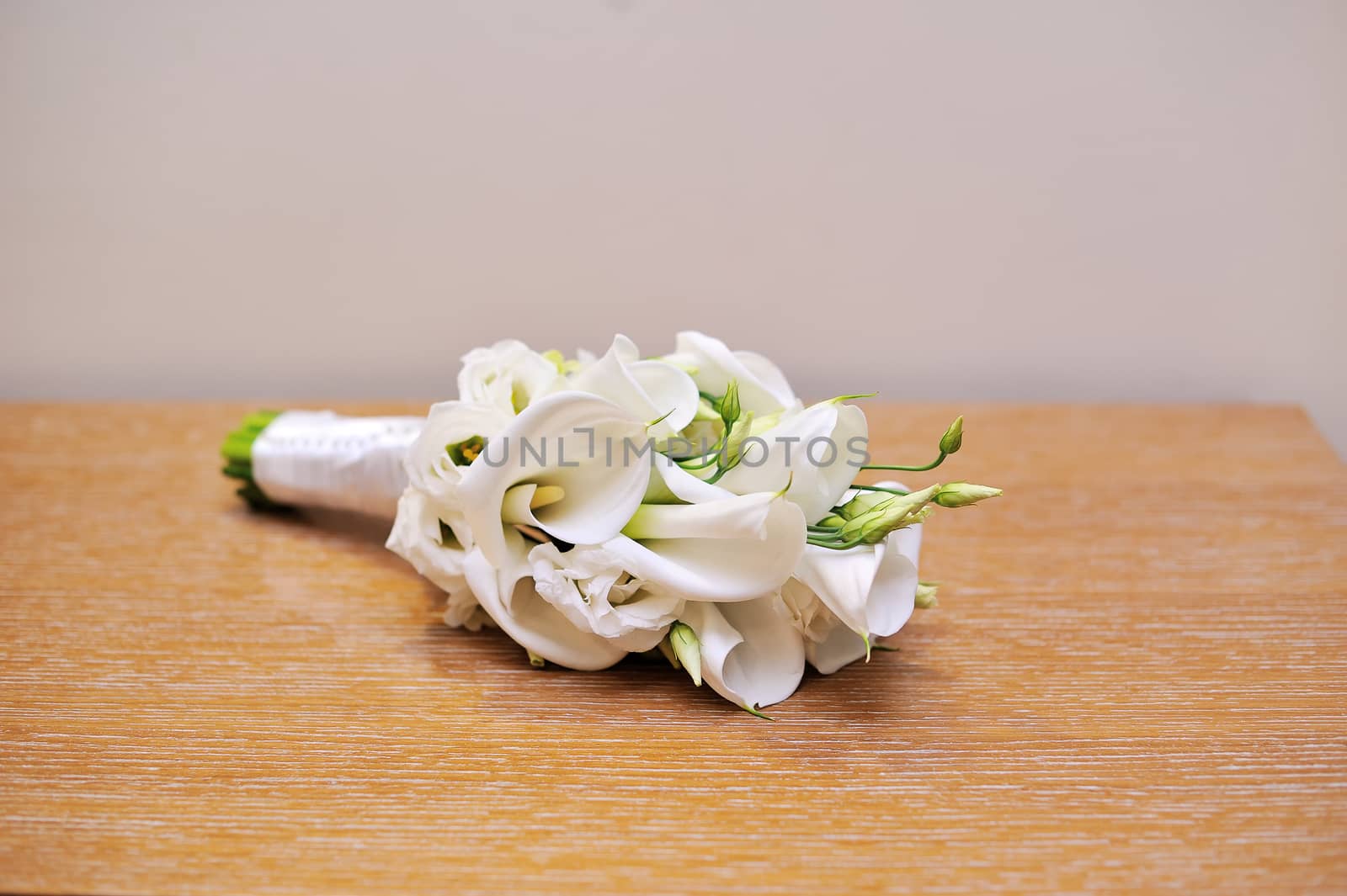 Wedding bouquet of bride lying on table by timonko