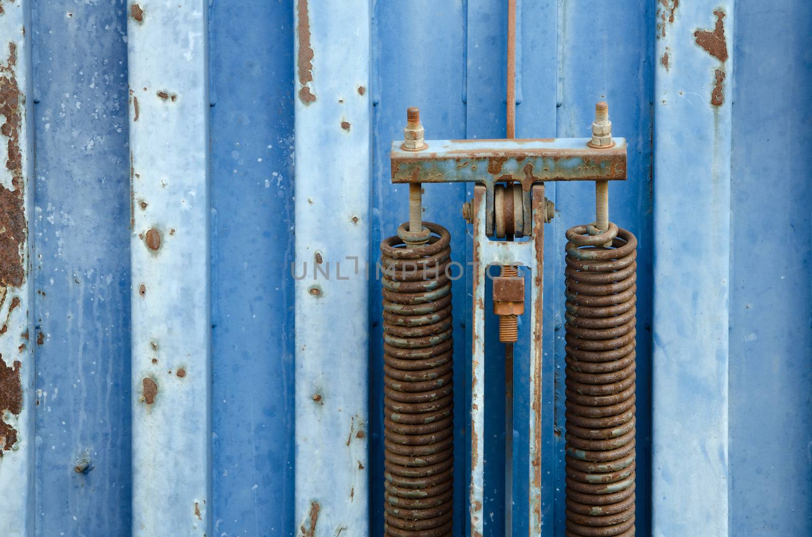 Detail of old blue rusty metal container. 