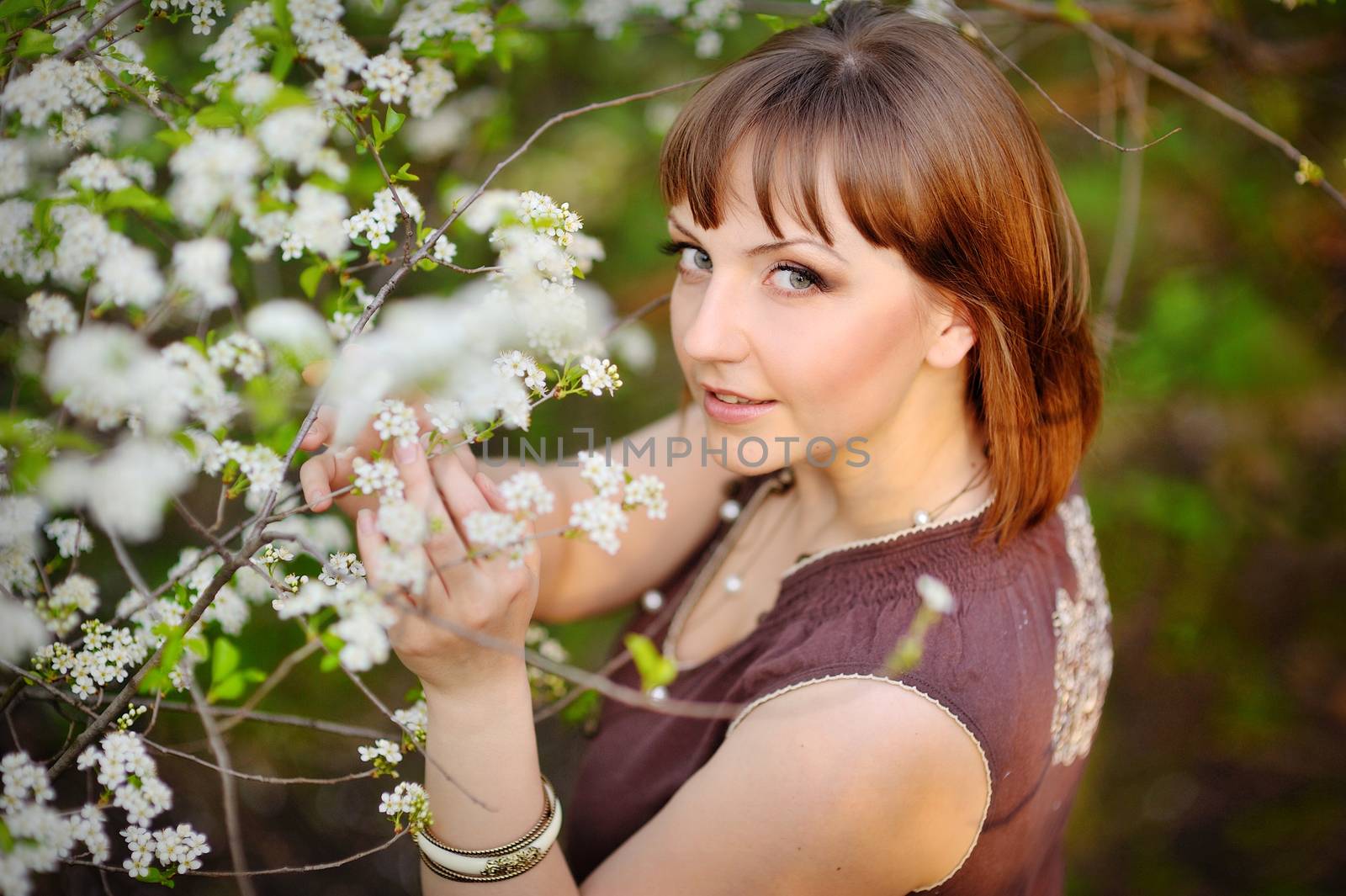 Beautiful young woman in a park on a spring day.