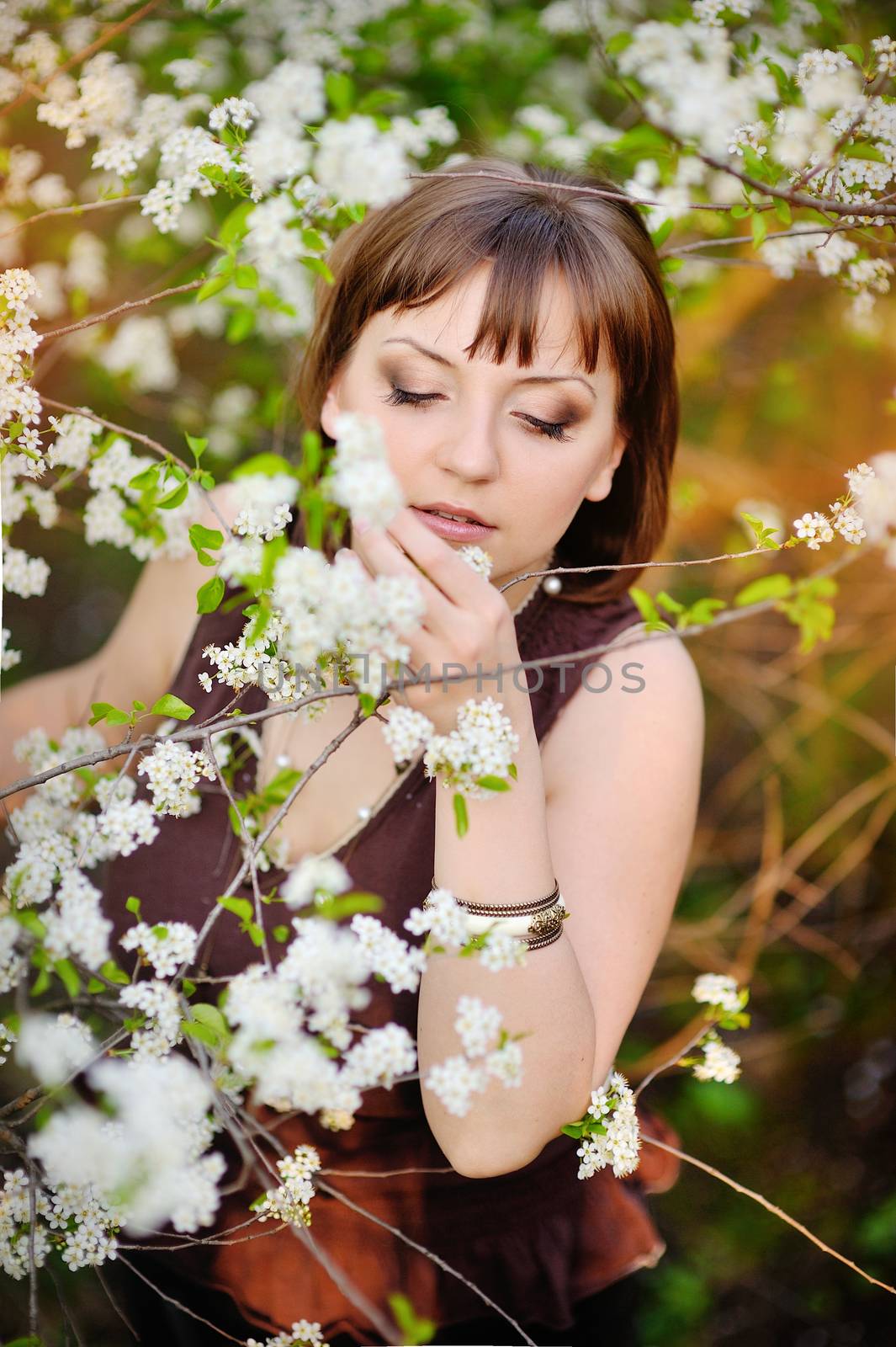 beautiful woman in spring cherry garden.