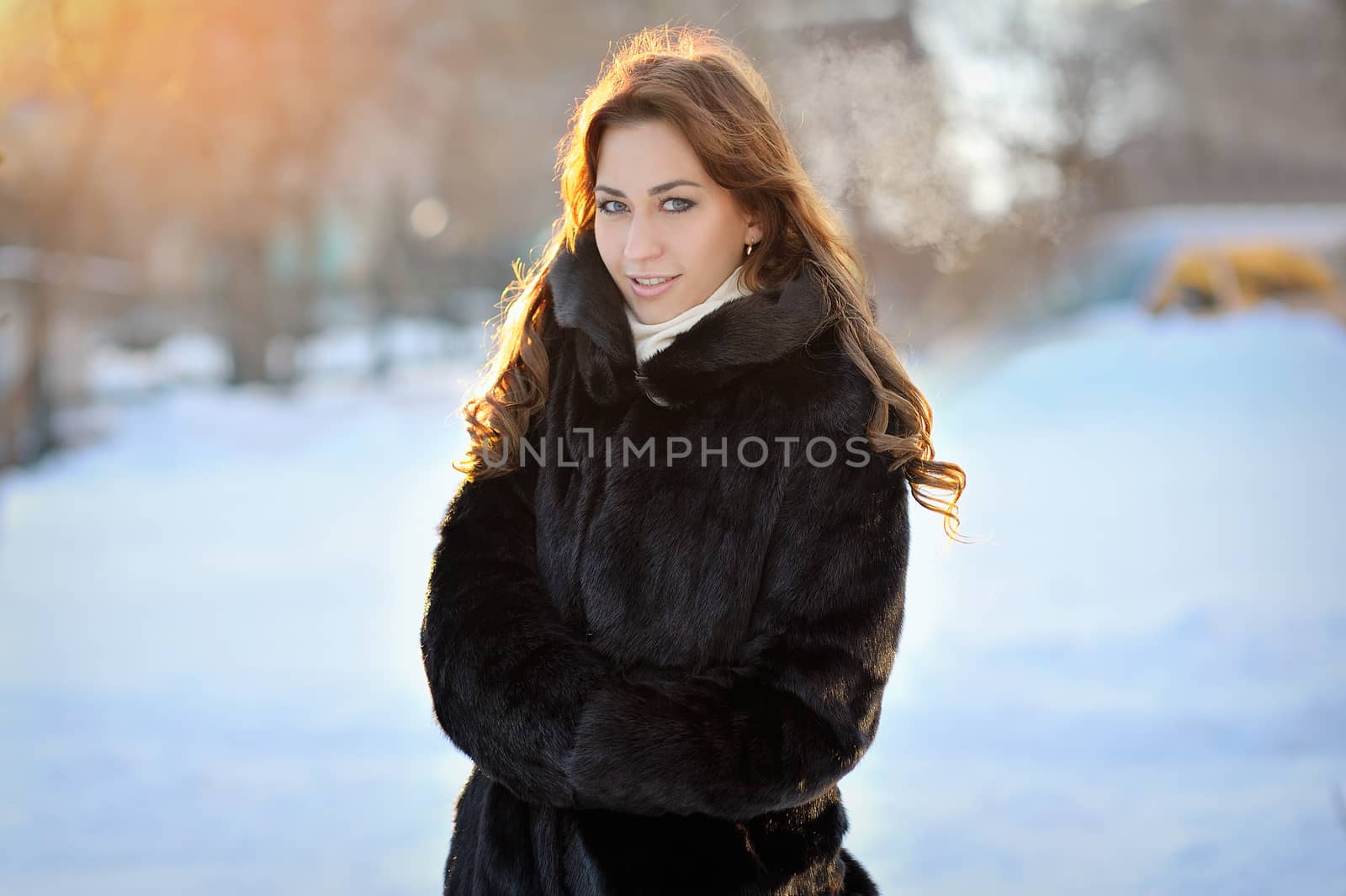 beautiful girl in brown winter coat on the street.