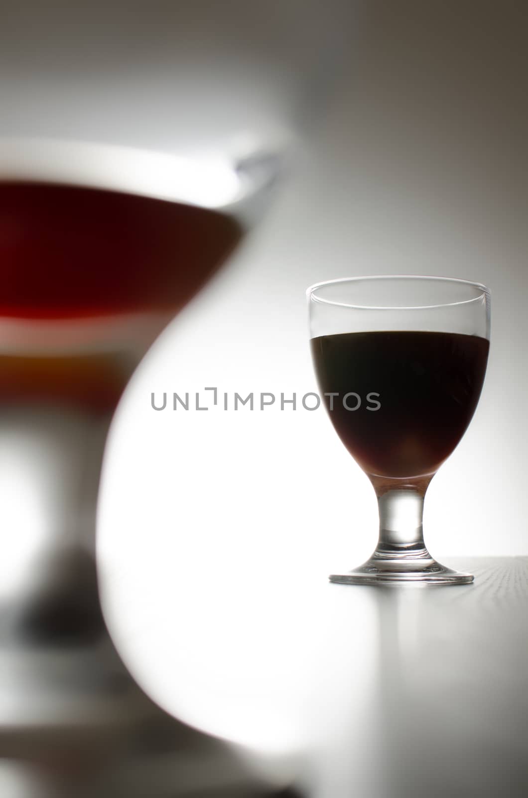 Two glasses of red wine isolated on background. 