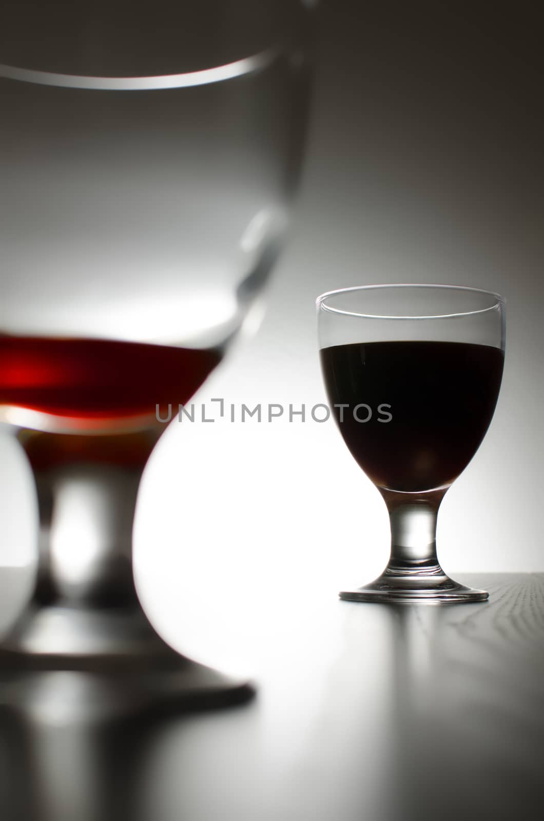 Two glasses of red wine isolated on background. 