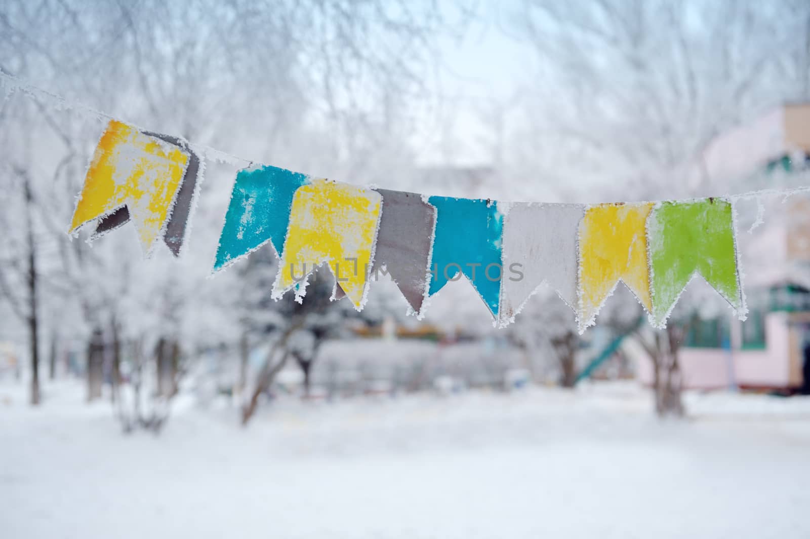 colored flags on a rope on the street in winter.