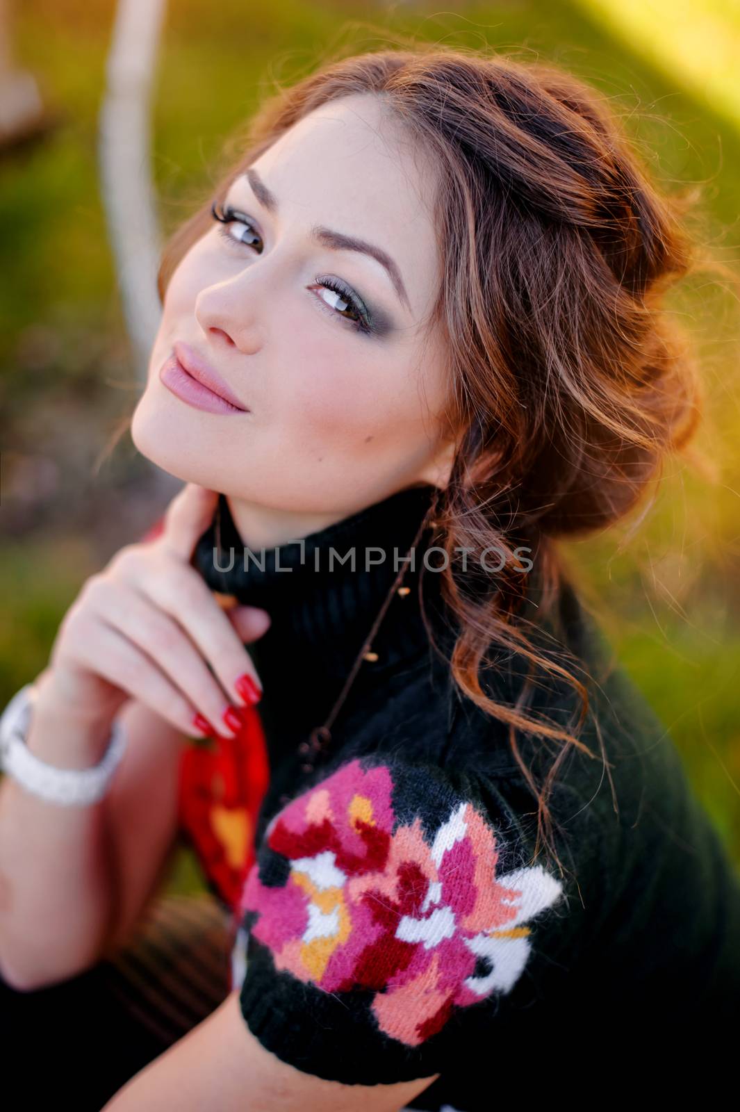 portrait of a cute brunette girl on nature background.