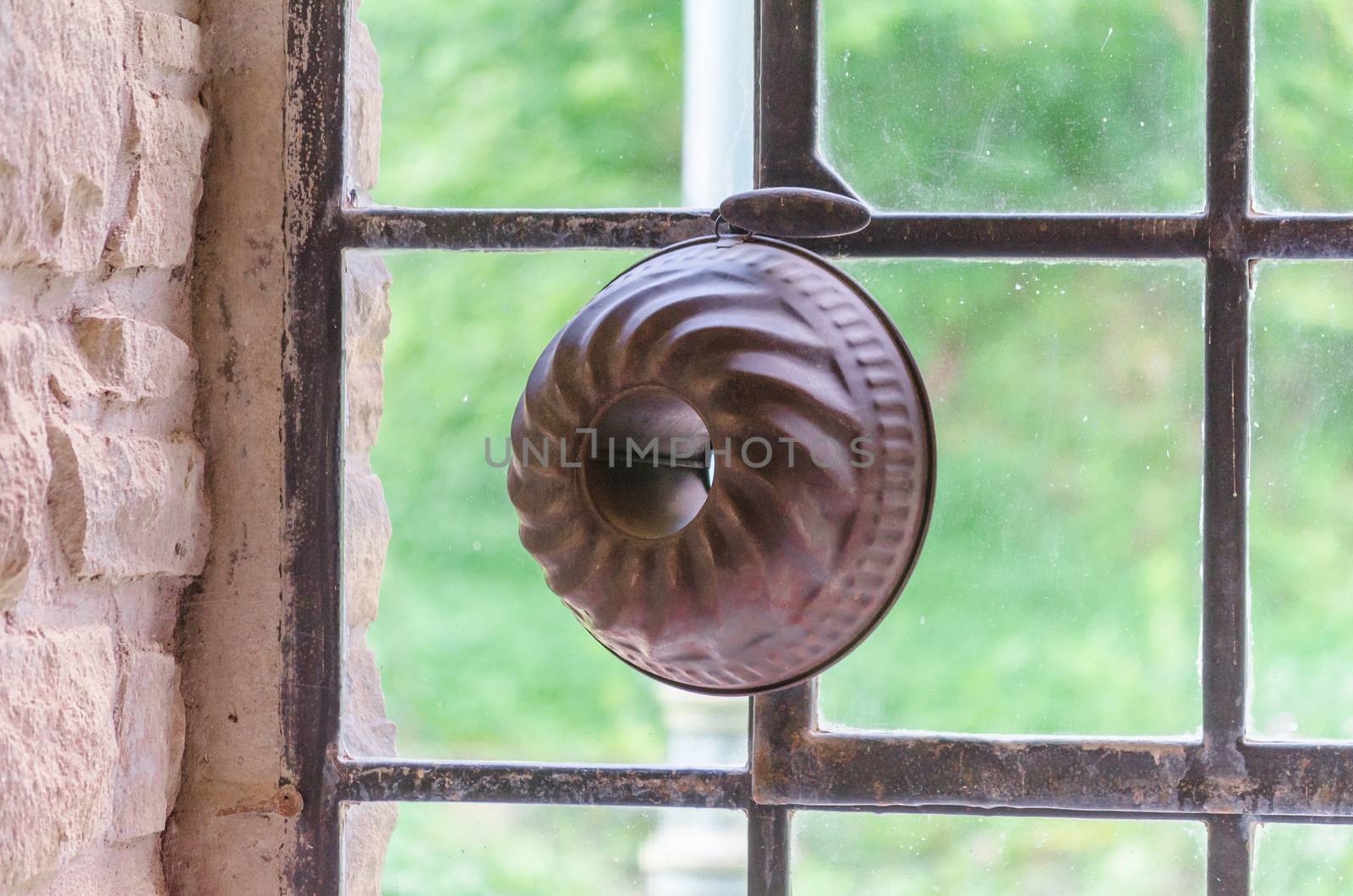 Cake baking pan front of an old industrial windows.