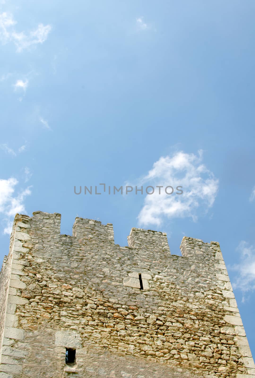 Square shape medieval tower built of stone.