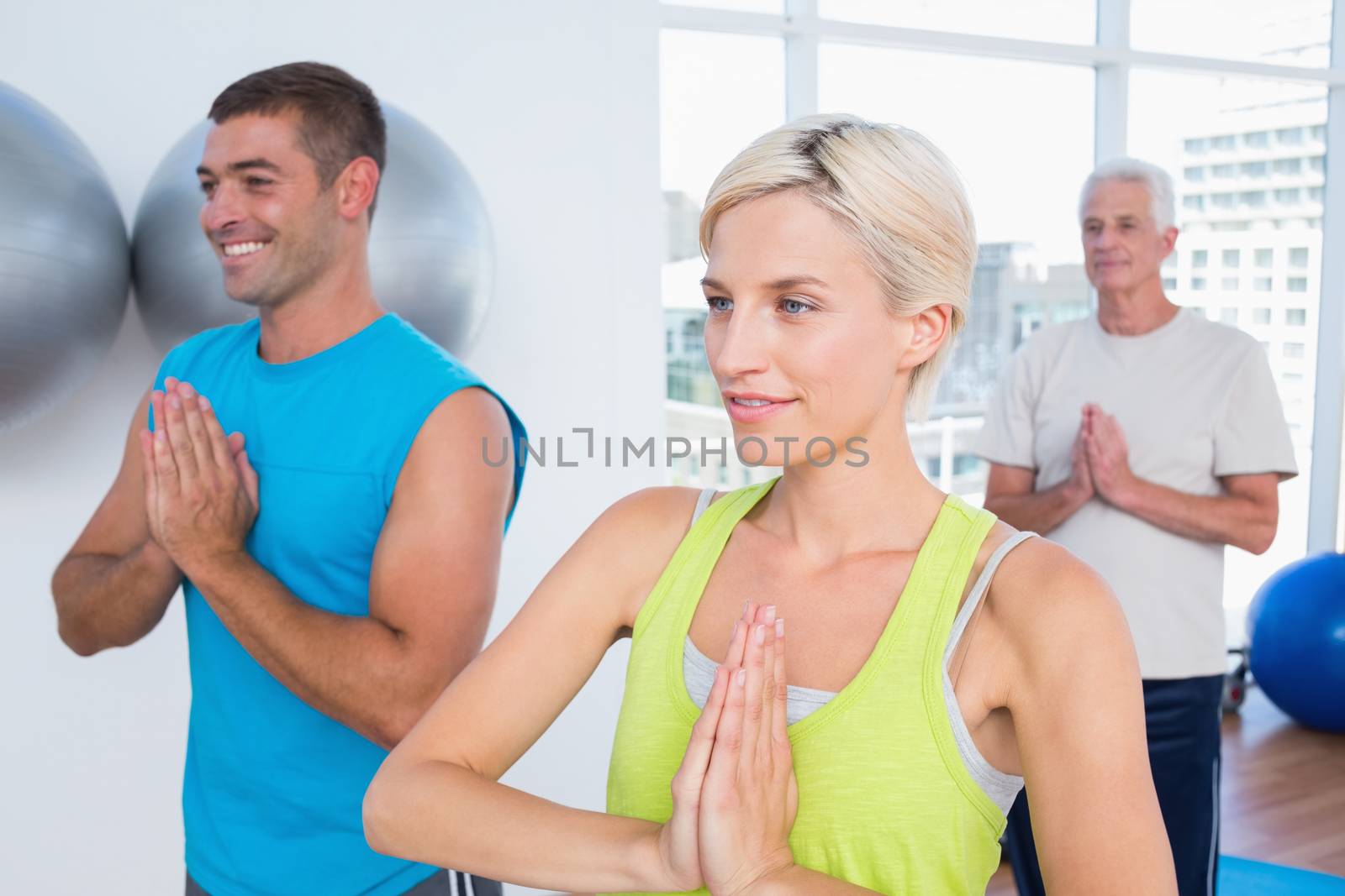 People meditating in fitness club by Wavebreakmedia