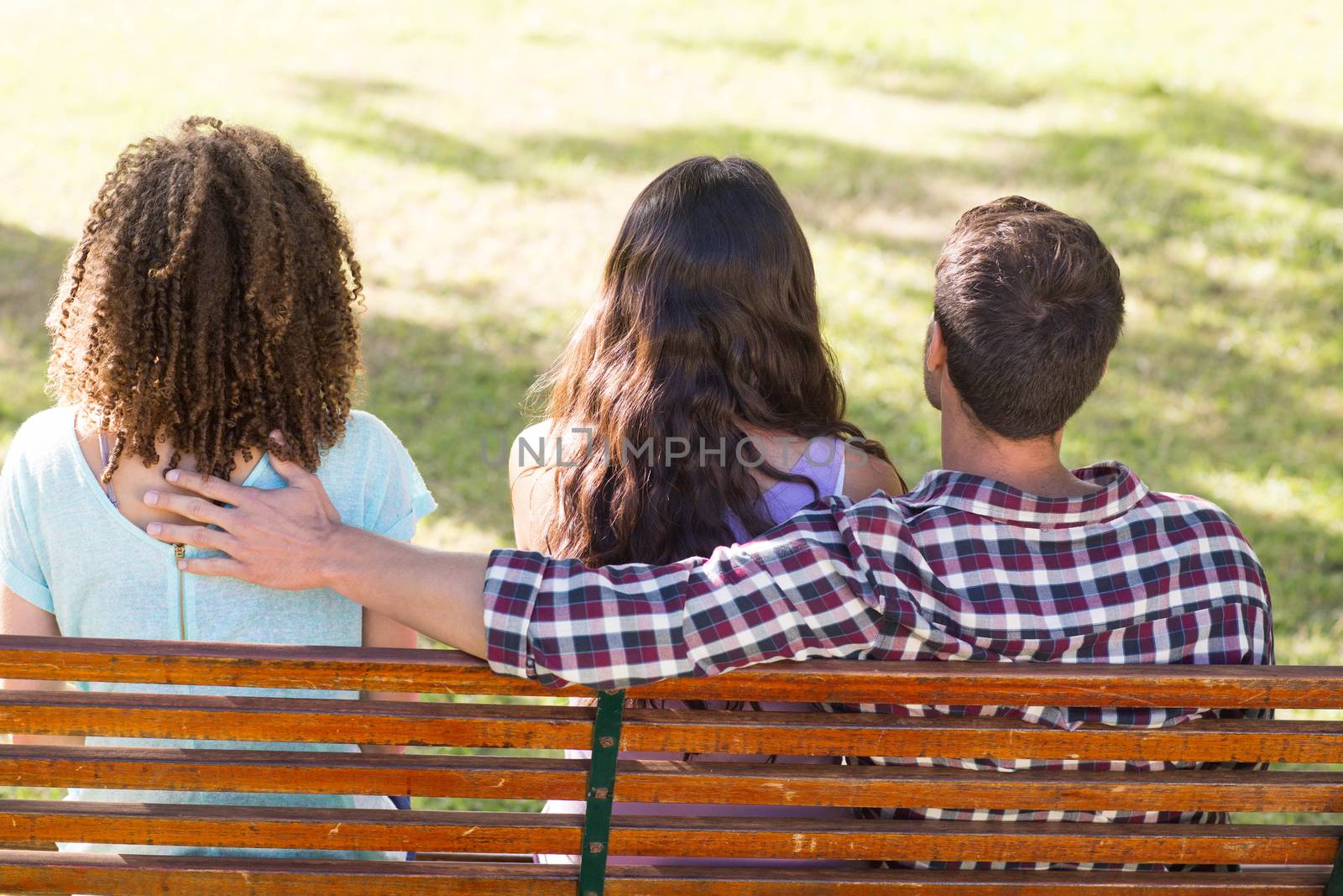 Man being unfaithful in the park by Wavebreakmedia