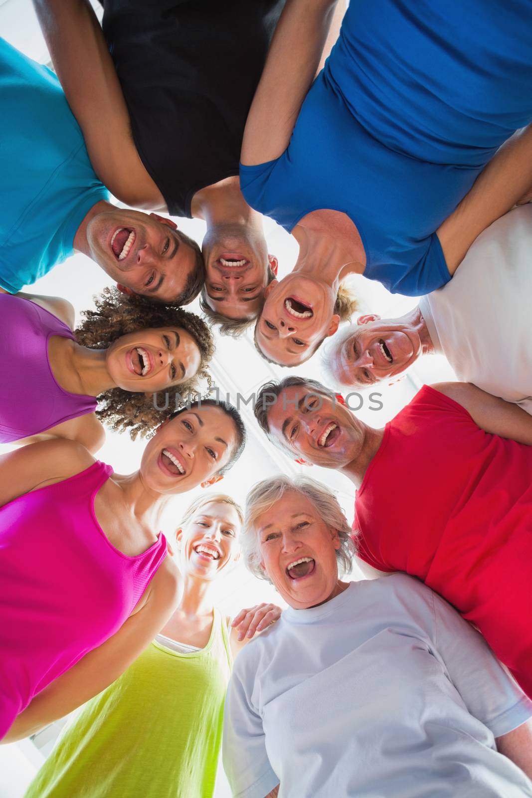Cheerful people forming huddle at gym by Wavebreakmedia