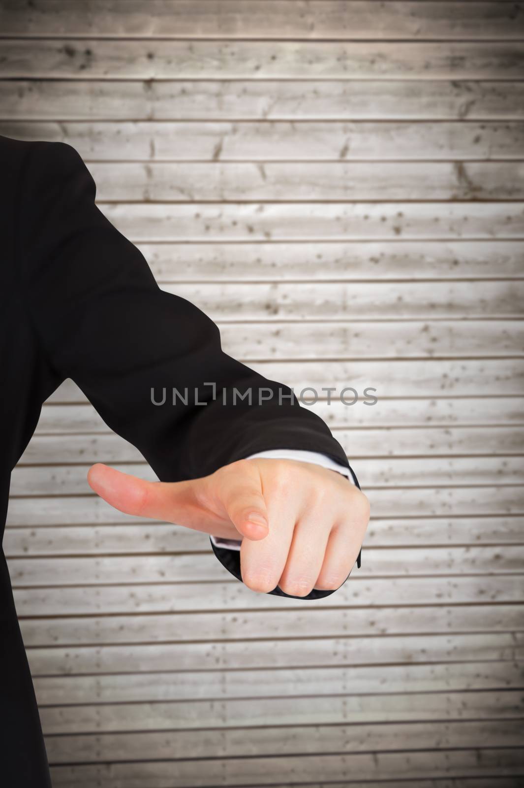 Businesswoman pointing against wooden planks background
