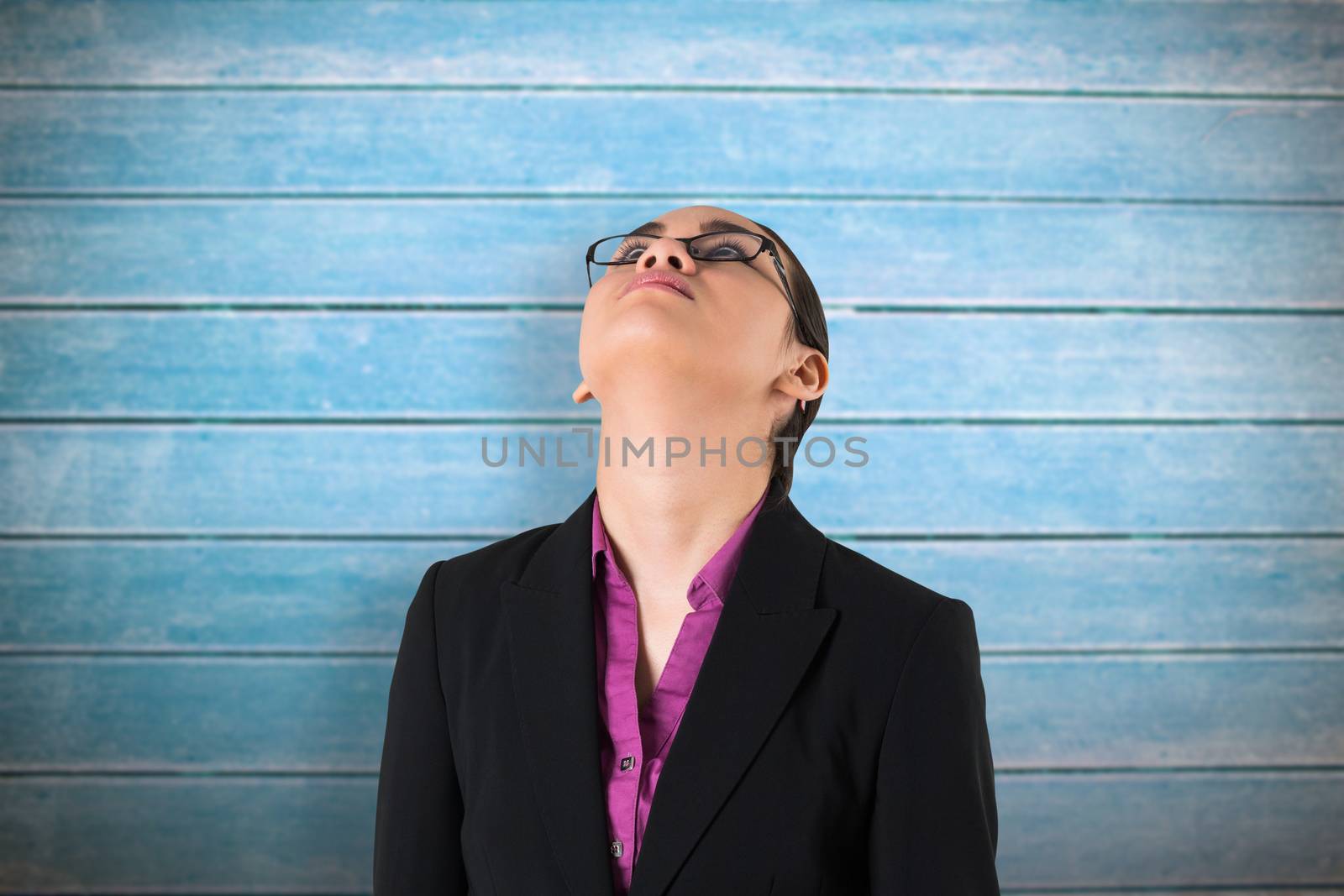 Businesswoman looking up against wooden planks