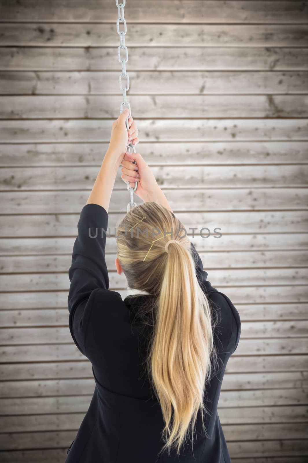 Composite image of businesswoman pulling a chain by Wavebreakmedia