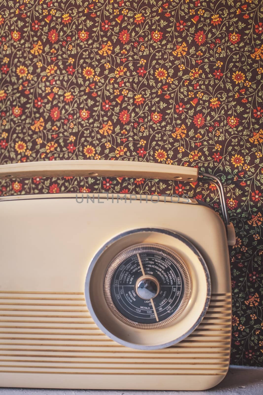Vintage Radio with old-fashioned patterned wallpaper in the background