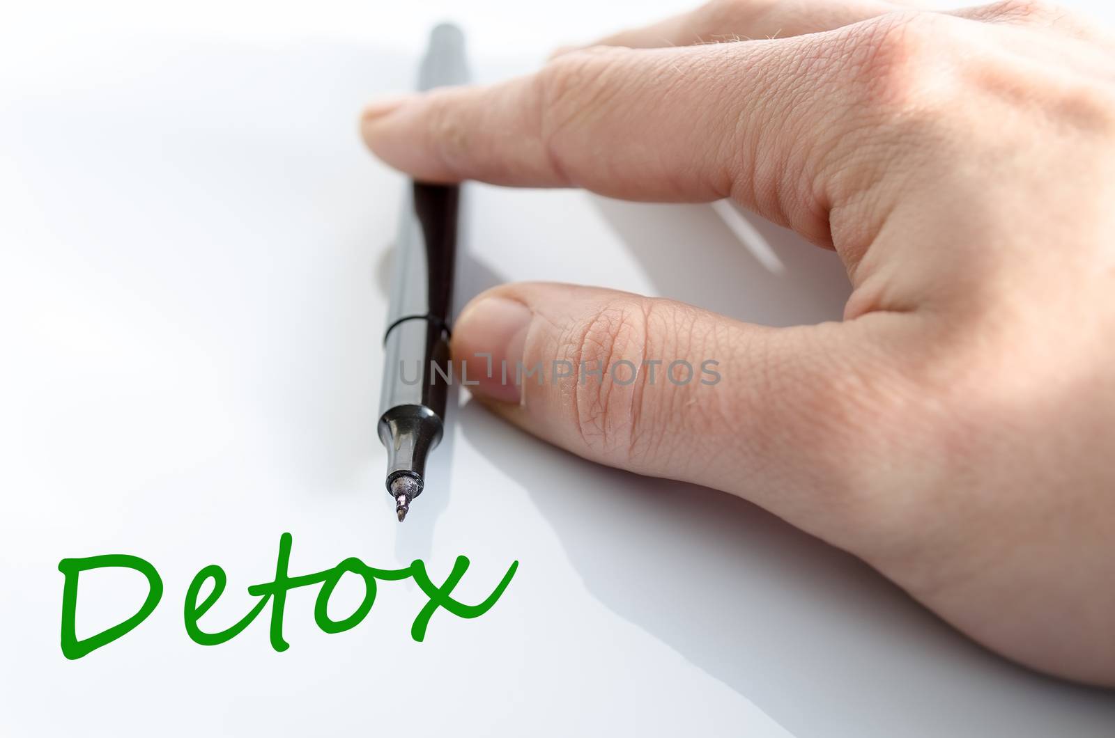 Pen in the hand isolated over white background detox concept