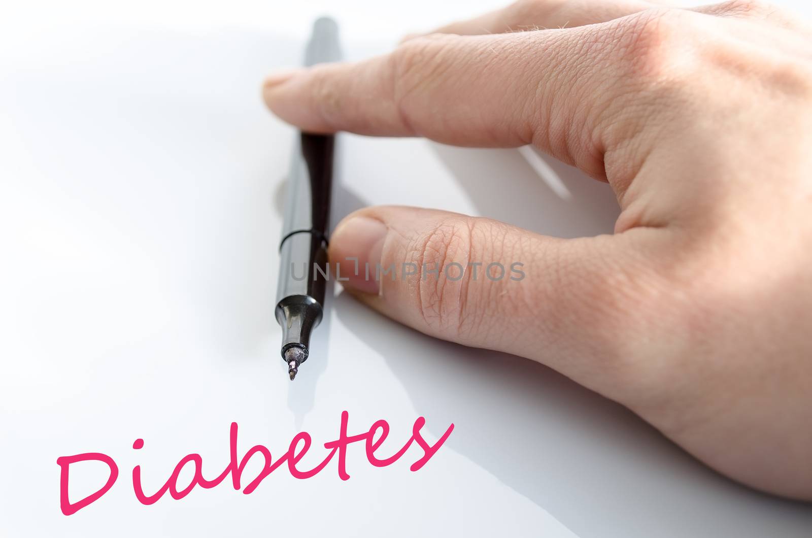Pen in the hand isolated over white background diabetes concept