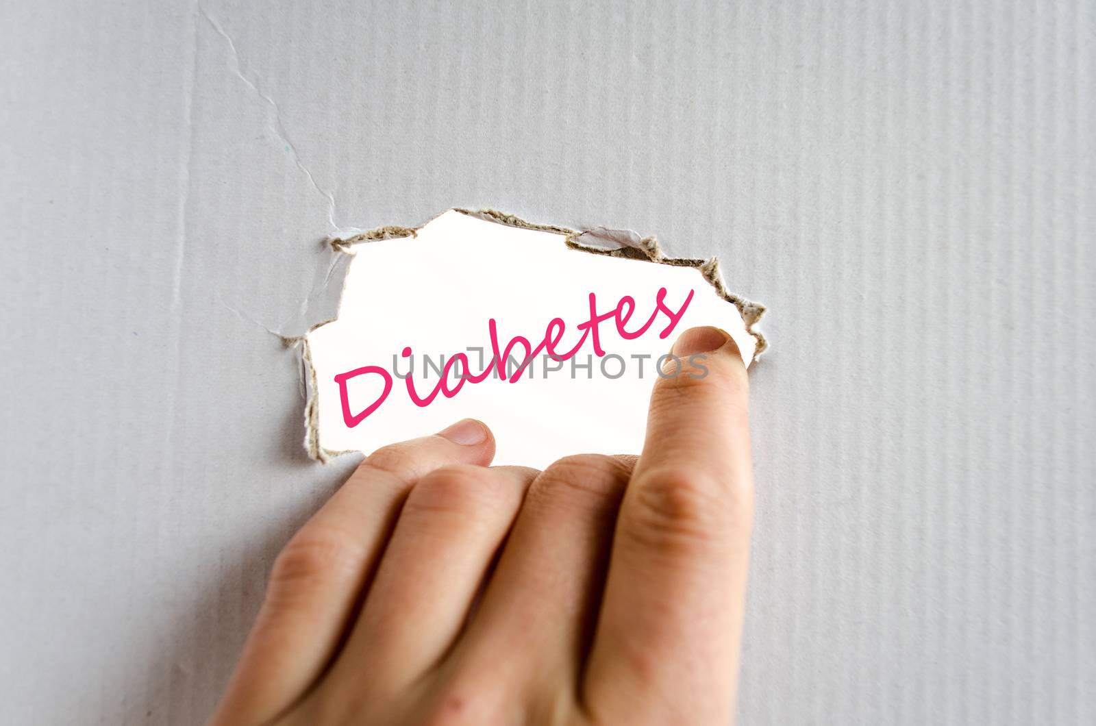 Hand on the cardboard background diabetes concept