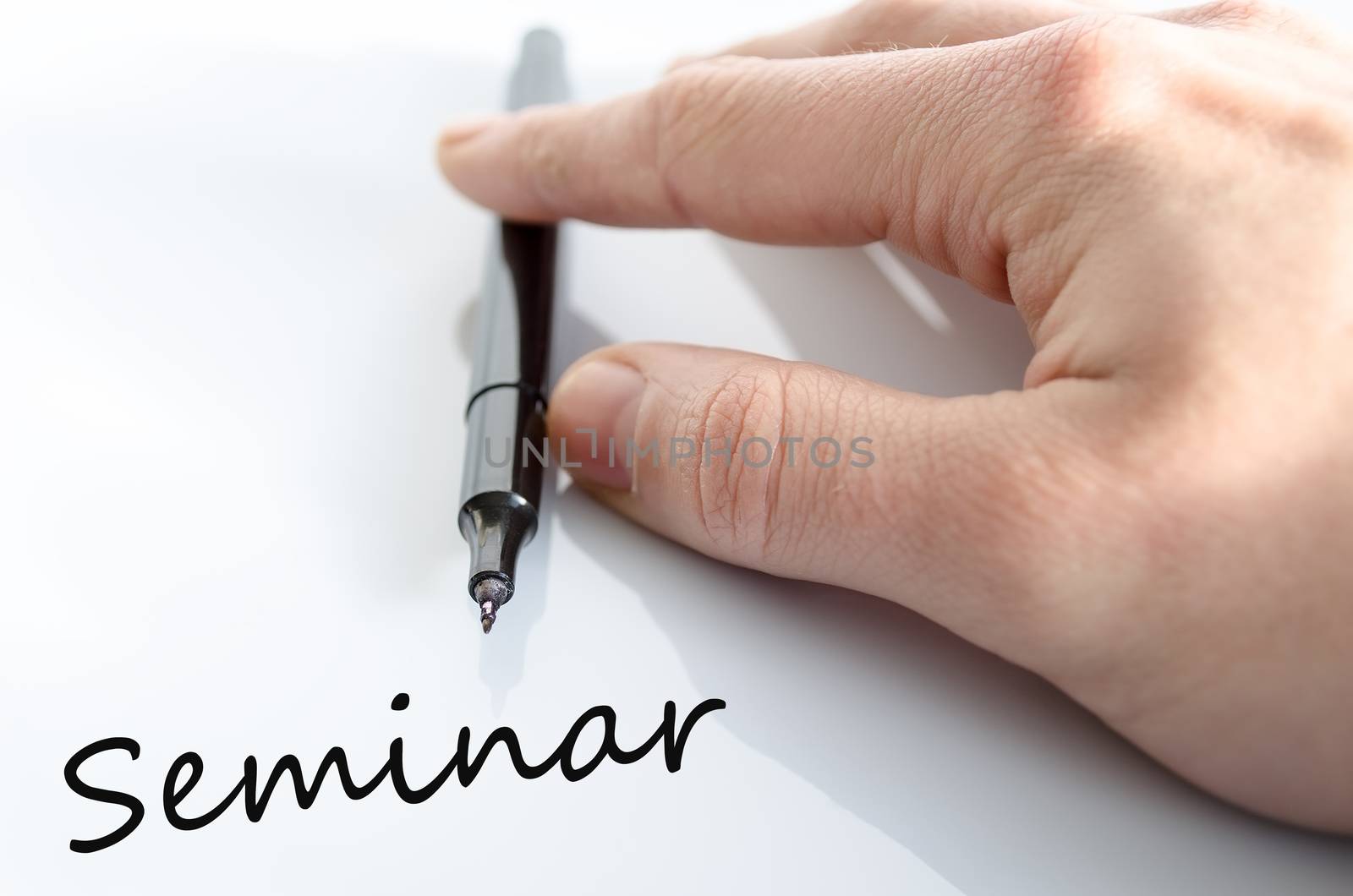 Pen in the hand isolated over white background seminar concept