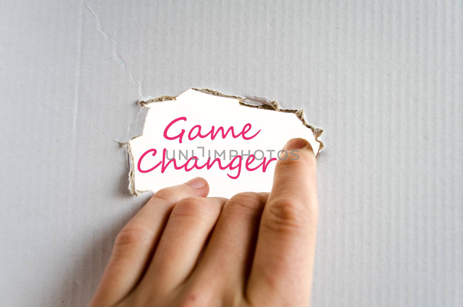 Hand on the cardboard background game changer concept
