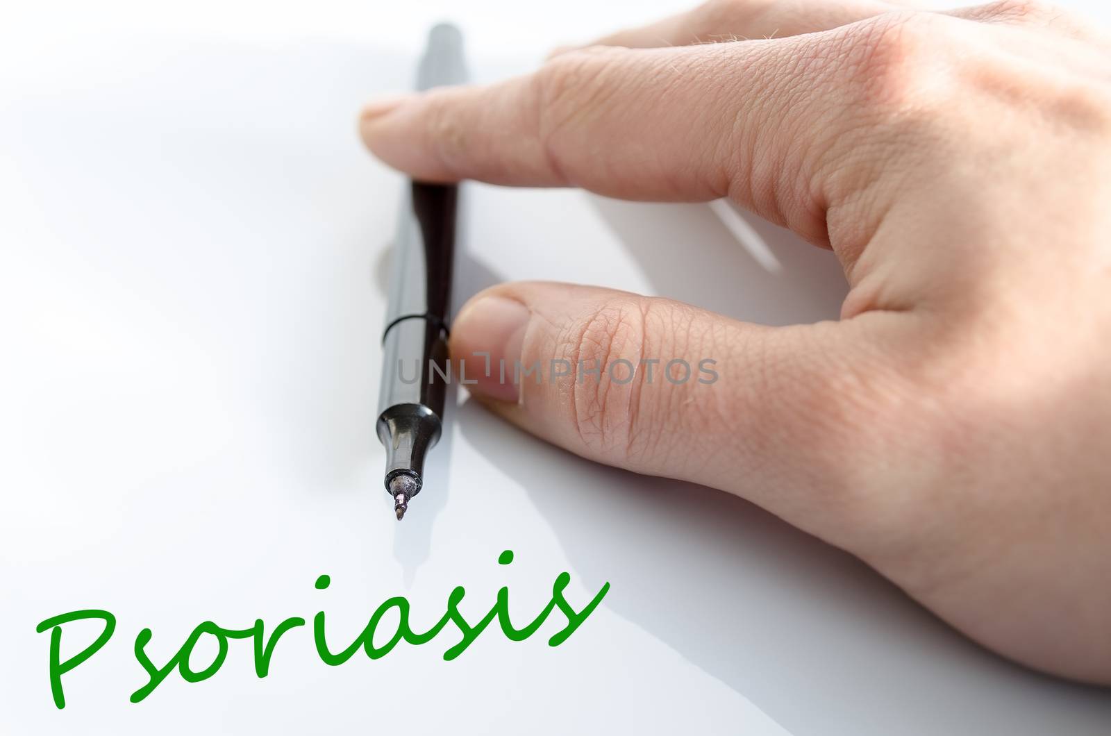 Pen in the hand isolated over white background psoriasis concept
