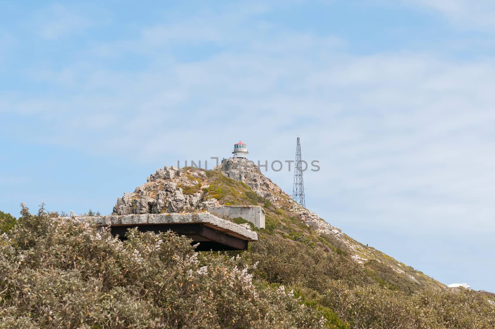 CAPE TOWN, SOUTH AFRICA - DECEMBER 12, 2014:  View from Dias Point at Cape Point towards the historic first lighthouse with a derelict military observation post from World War II in front