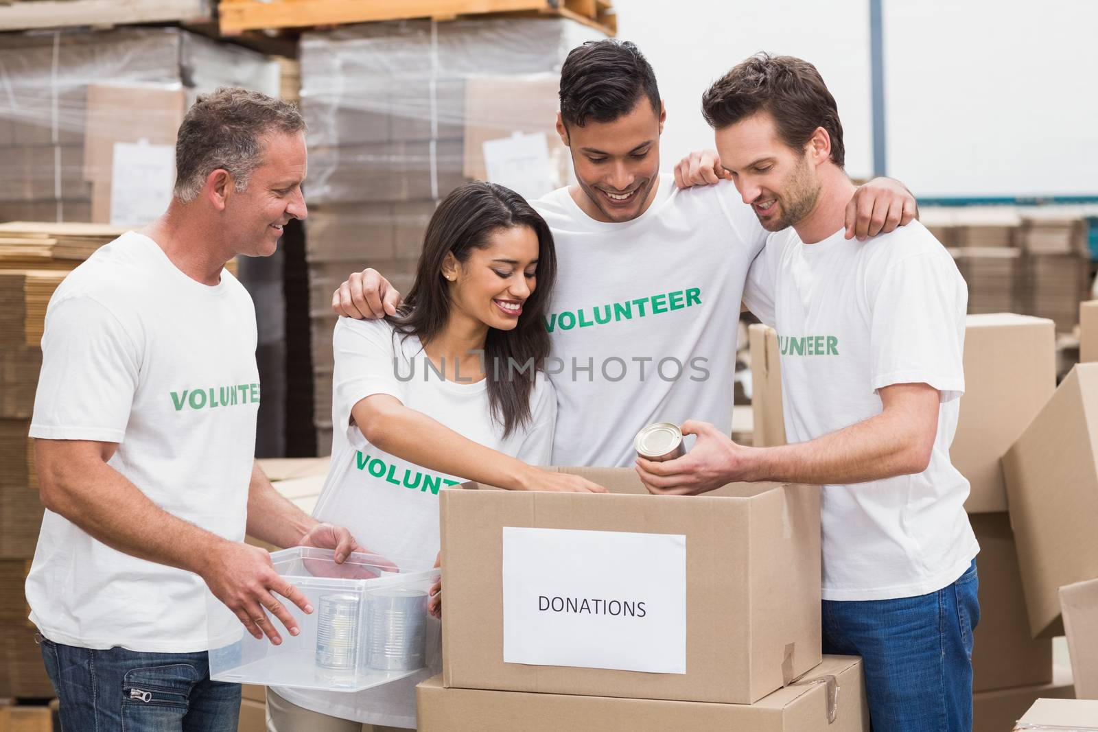 Volunteer team packing a food donation box by Wavebreakmedia
