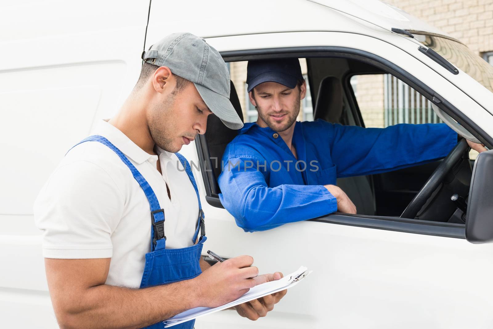 Delivery man getting signature from customer by Wavebreakmedia
