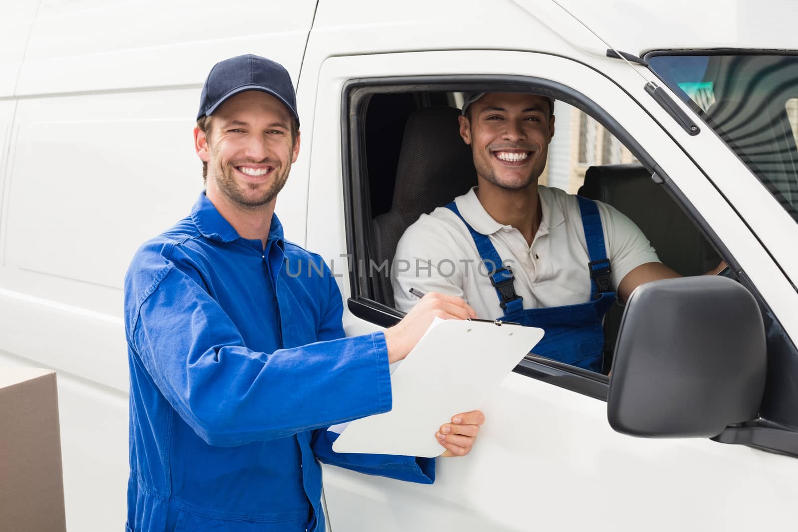 Delivery driver showing customer where to sign outside the warehouse