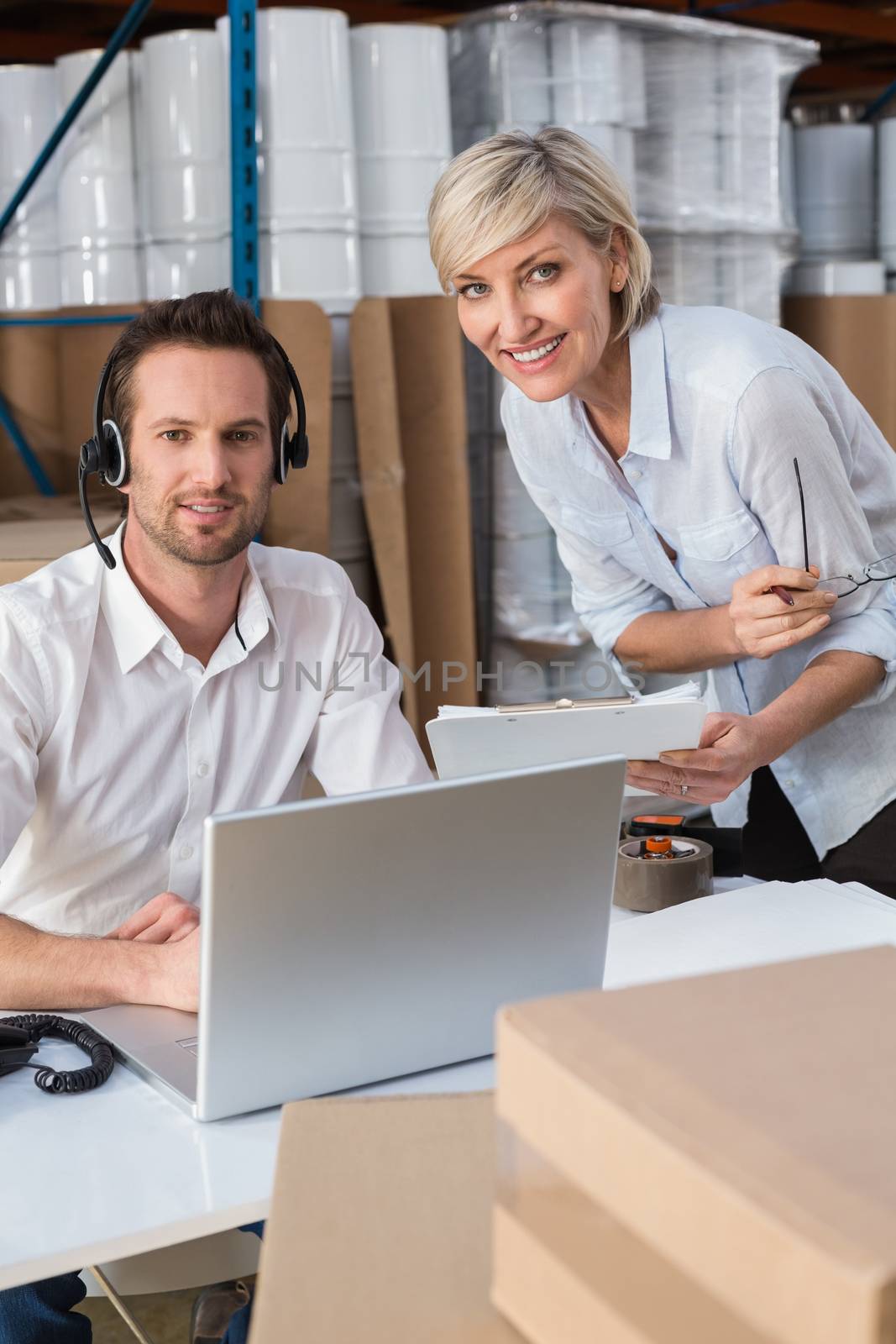 Warehouse team smiling at camera by Wavebreakmedia