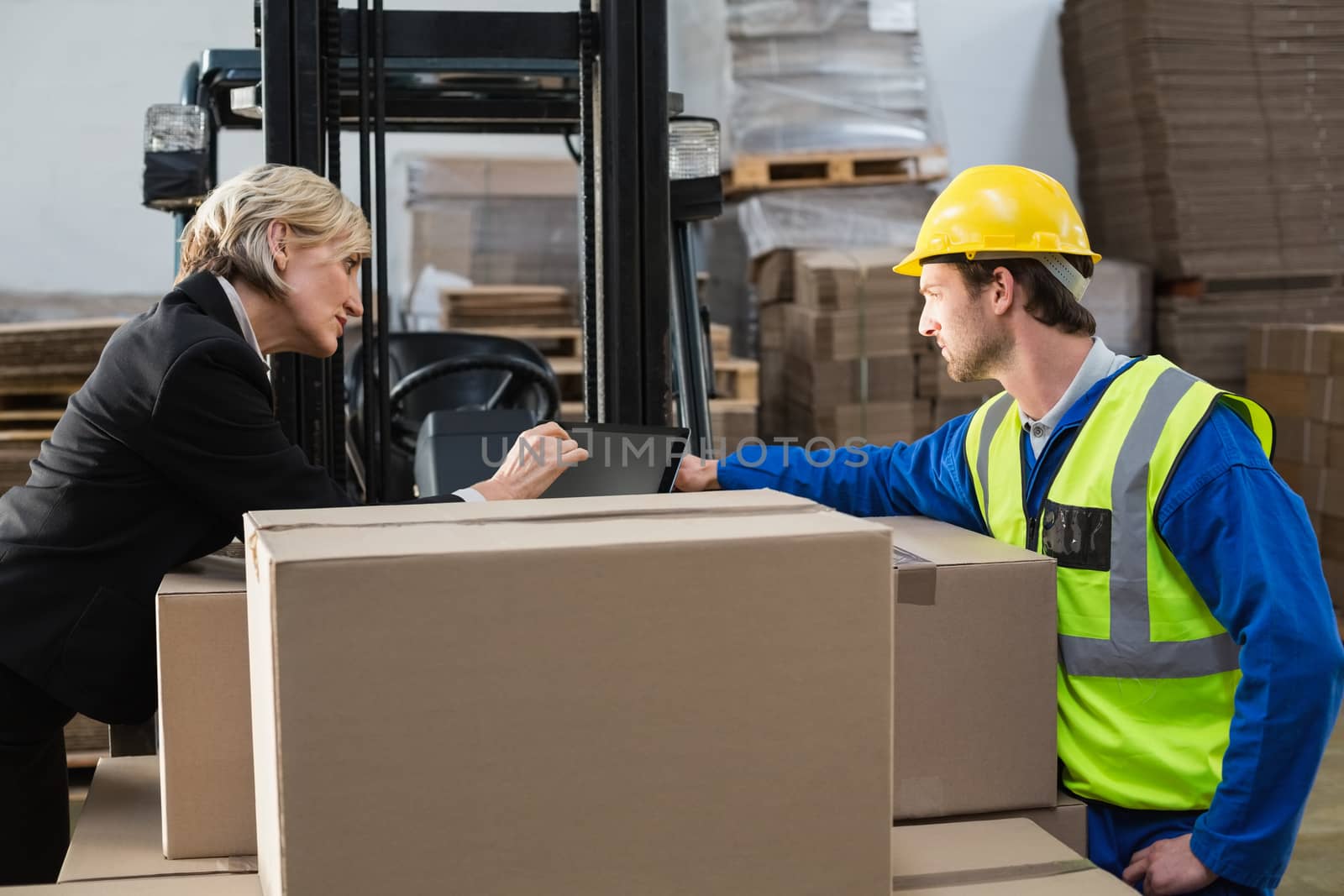 Warehouse worker and manager using tablet pc by Wavebreakmedia
