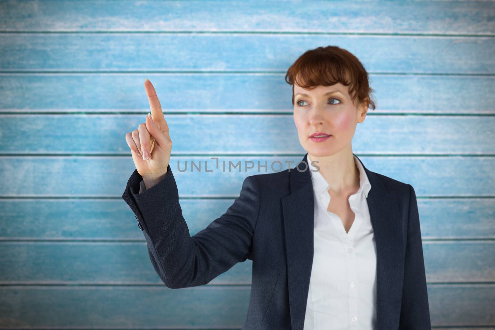 Businesswoman pointing against wooden planks
