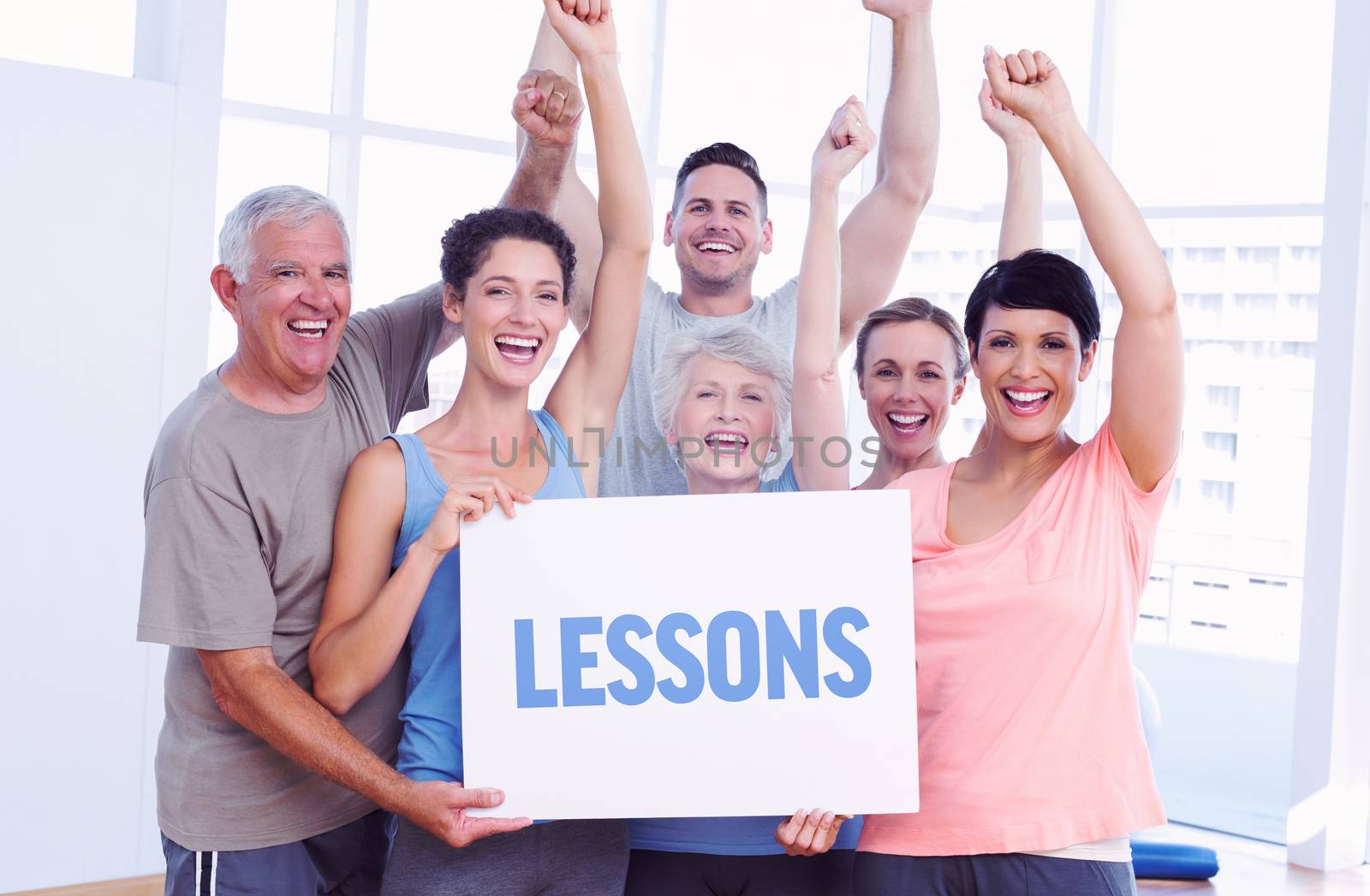 Lessons against portrait of happy fit people holding blank board by Wavebreakmedia