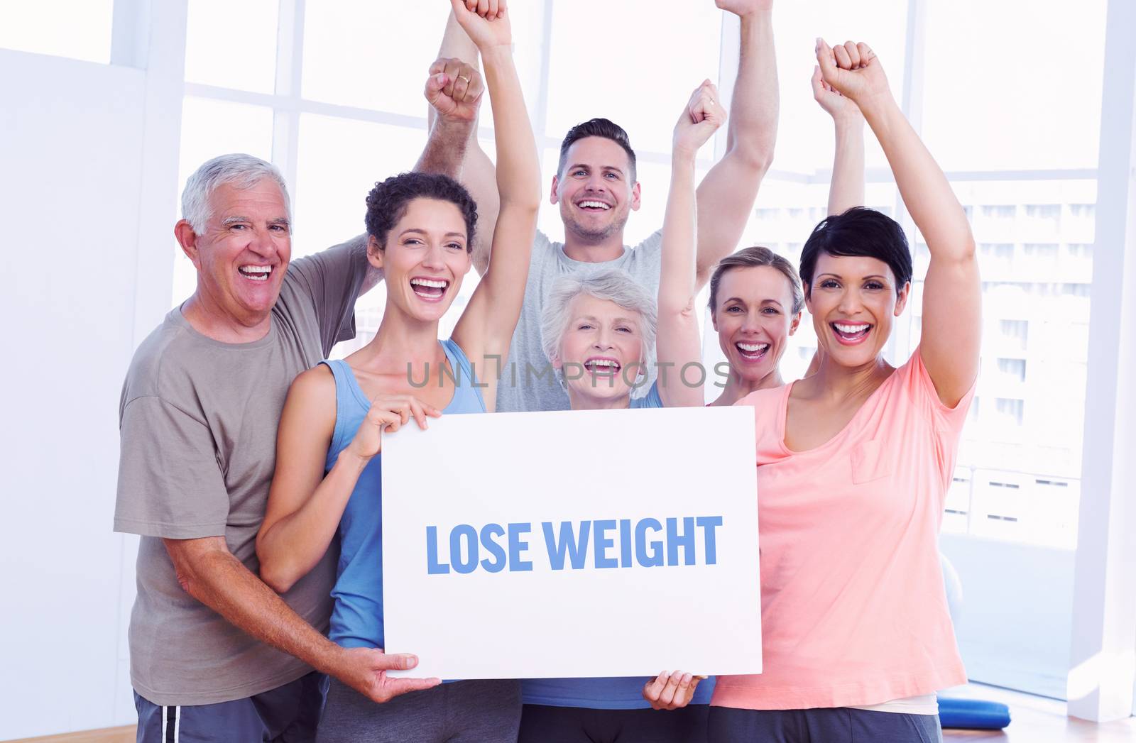 The word lose weight against portrait of happy fit people holding blank board
