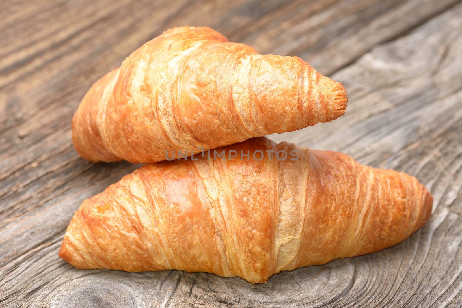Croissants on the wooden table by comet