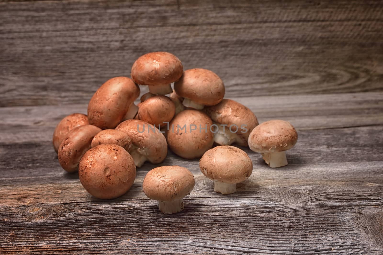 Brown champignon mushrooms on the table by comet