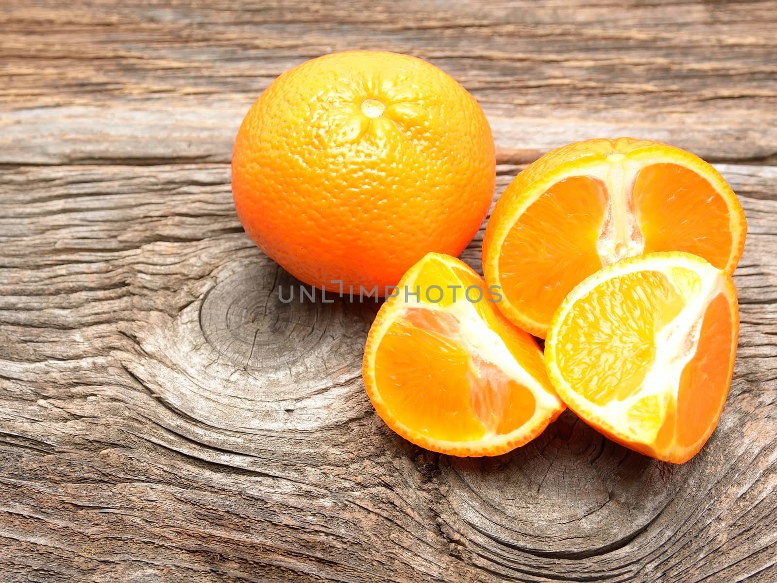 half an orange on old table