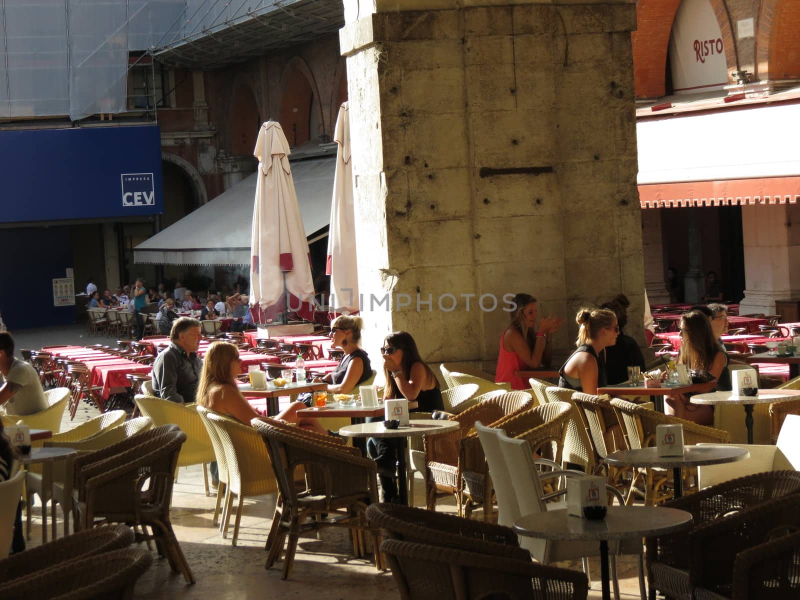 TREVISO, ITALY - CIRCA JULY 2014: customers sitting at an outdoor cafe in the piazza