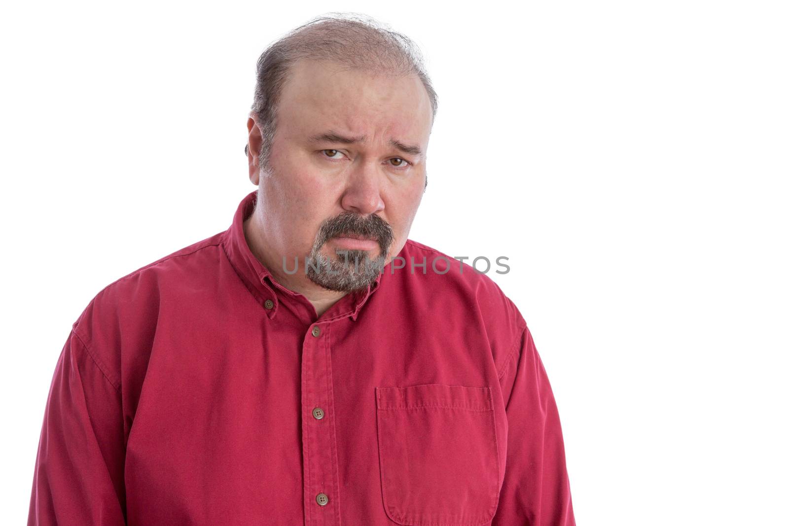 Upset and disappointed bald frowning middle-aged man looking at camera with a depressed facial expression, isolated portrait on white
