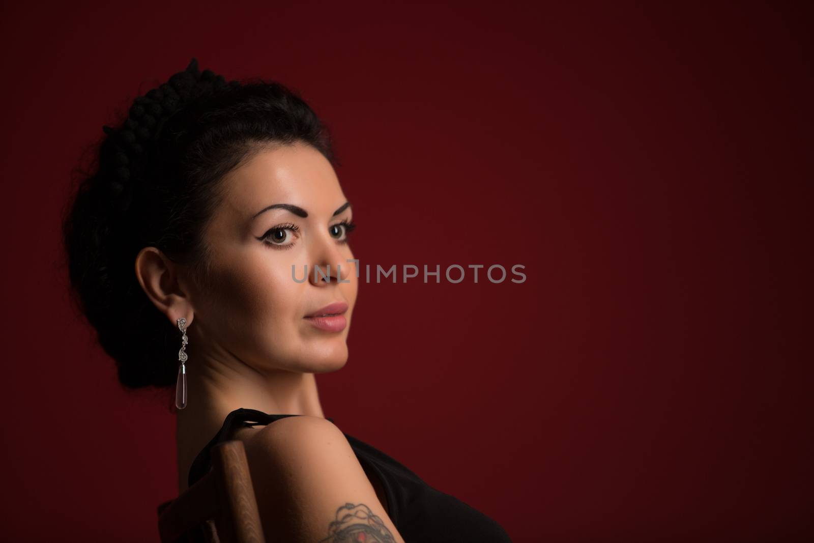 Portrait of beautiful female model on red background