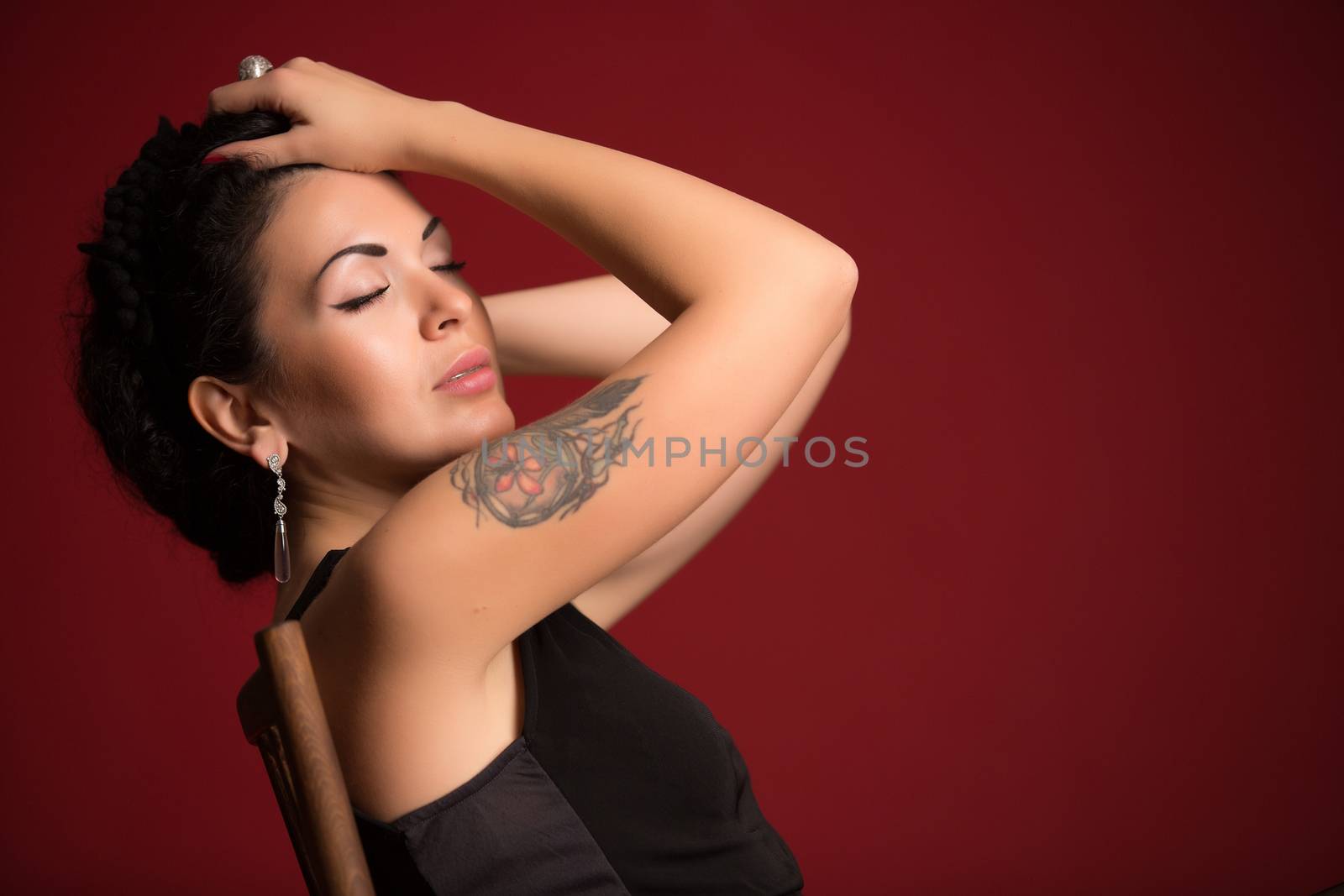 Portrait of beautiful female model on red background